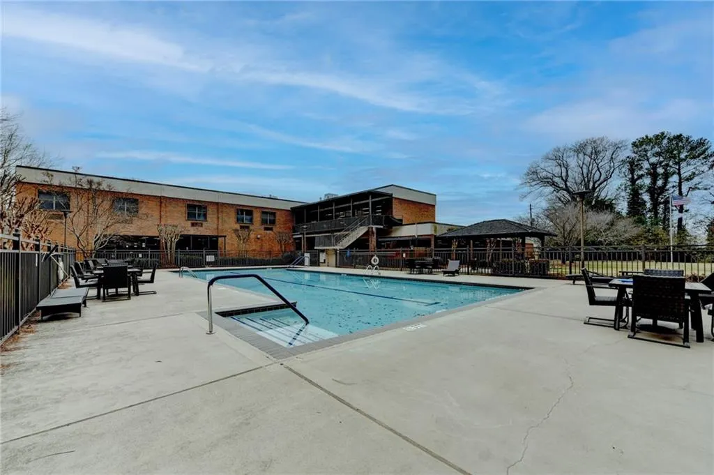 View of pool with a patio area and a gazebo