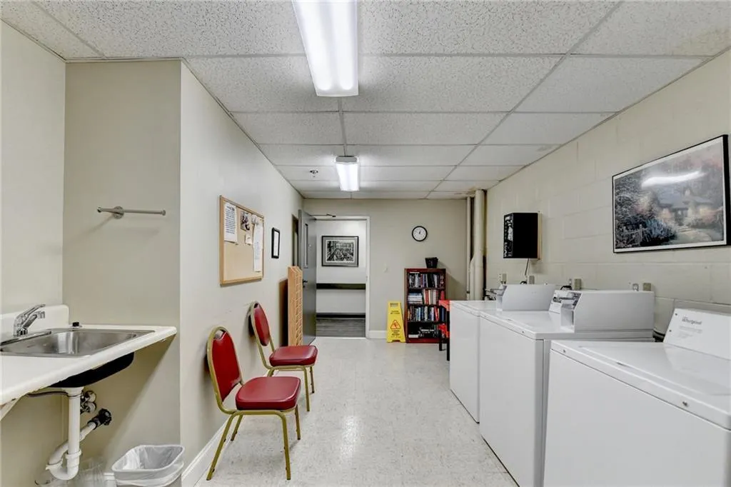 Clothes washing area featuring washer and dryer