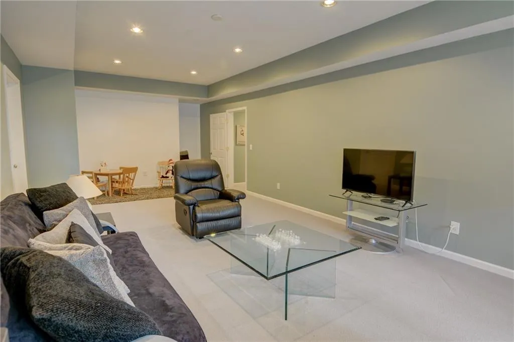 Living room with carpet flooring and recessed lighting