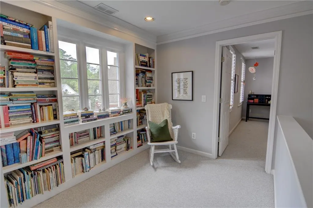 Living area featuring light carpet, ornamental molding, and recessed lighting