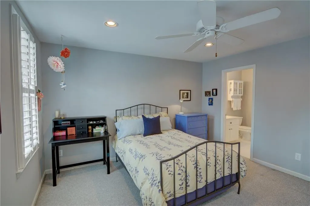 Bedroom with recessed lighting, ensuite bath, a ceiling fan, and light colored carpet