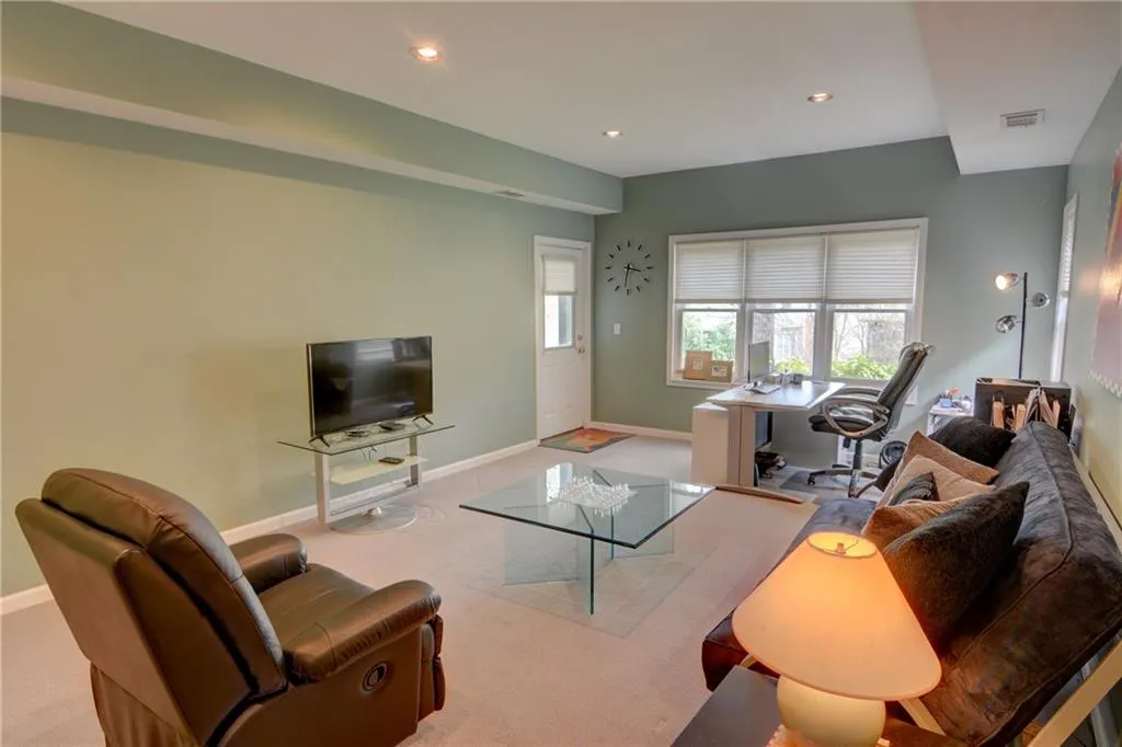 Living area with recessed lighting and carpet flooring