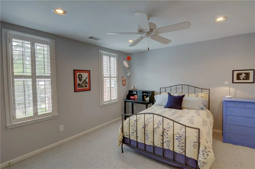 Carpeted bedroom with recessed lighting and ceiling fan