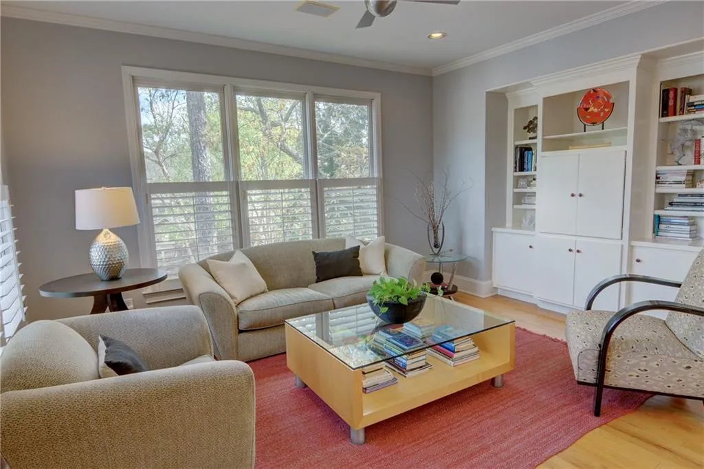Living area featuring light wood-type flooring, crown molding, a ceiling fan, and recessed lighting