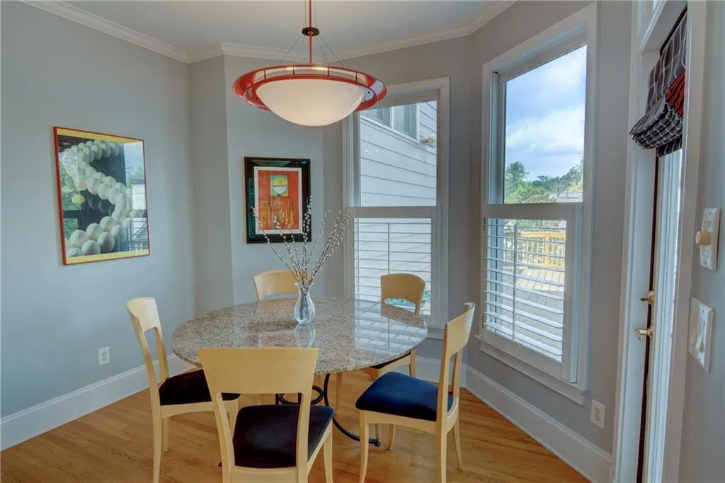 Dining room featuring ornamental molding and wood finished floors