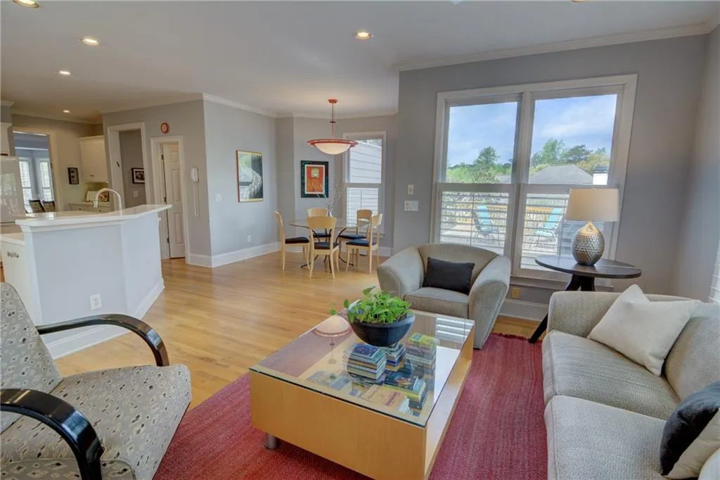 Living area with light wood-type flooring, crown molding, and recessed lighting