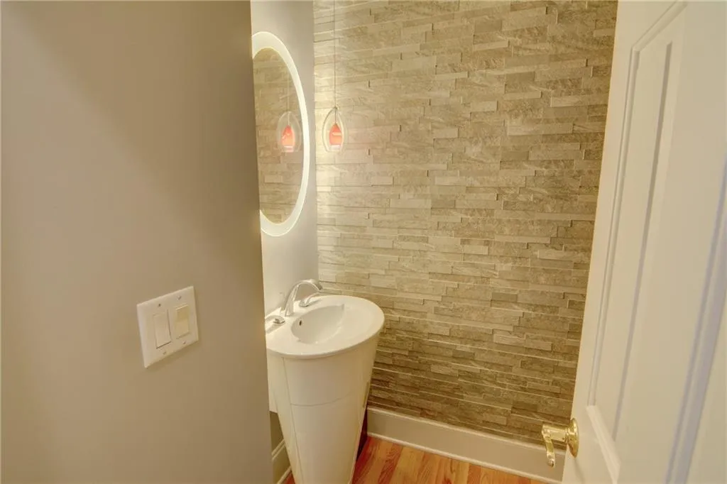 Bathroom featuring wood finished floors and baseboards
