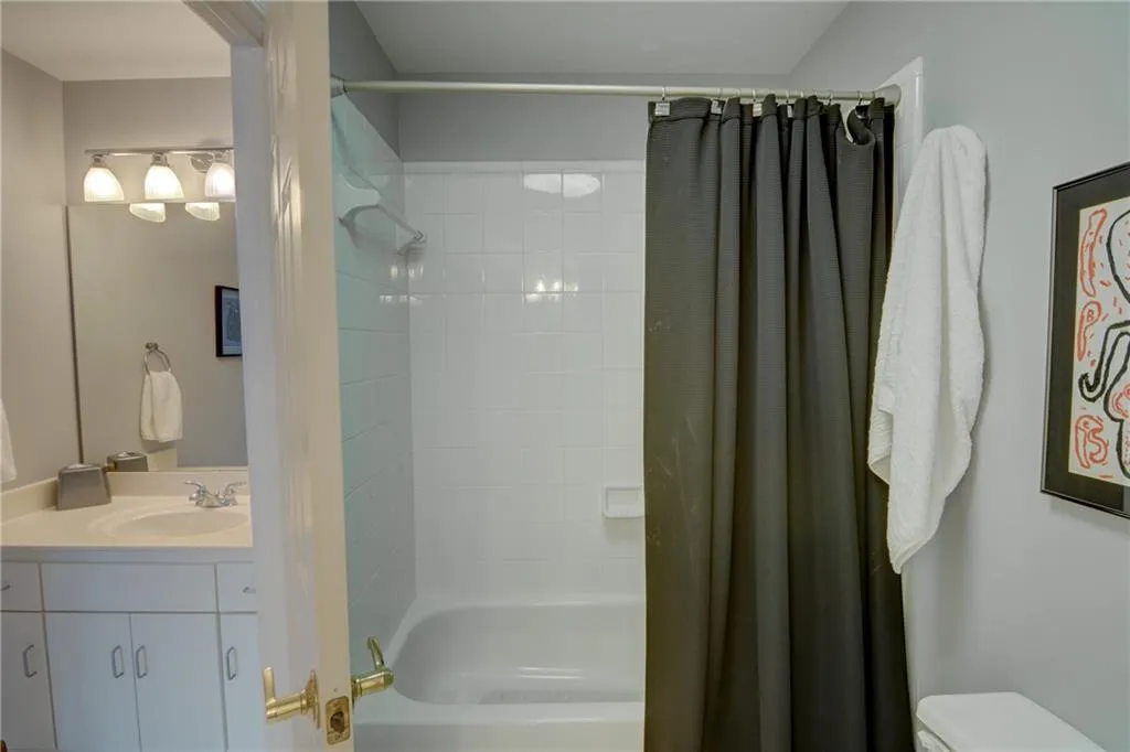 Full bathroom featuring shower / bath combo and vanity