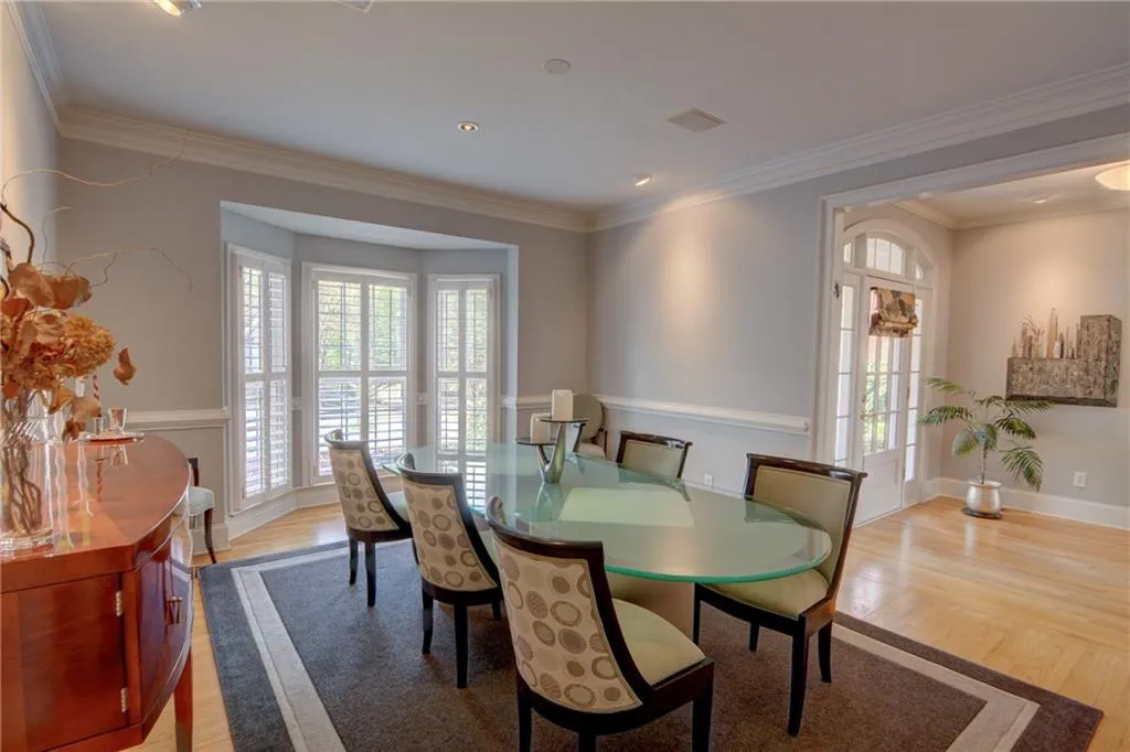Dining space with light wood-style floors and crown molding