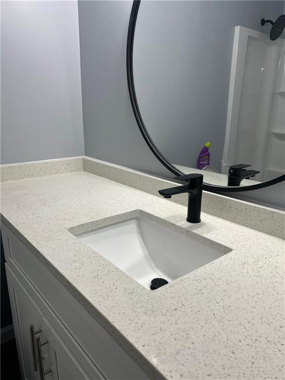 Bathroom with vanity with extensive cabinet space