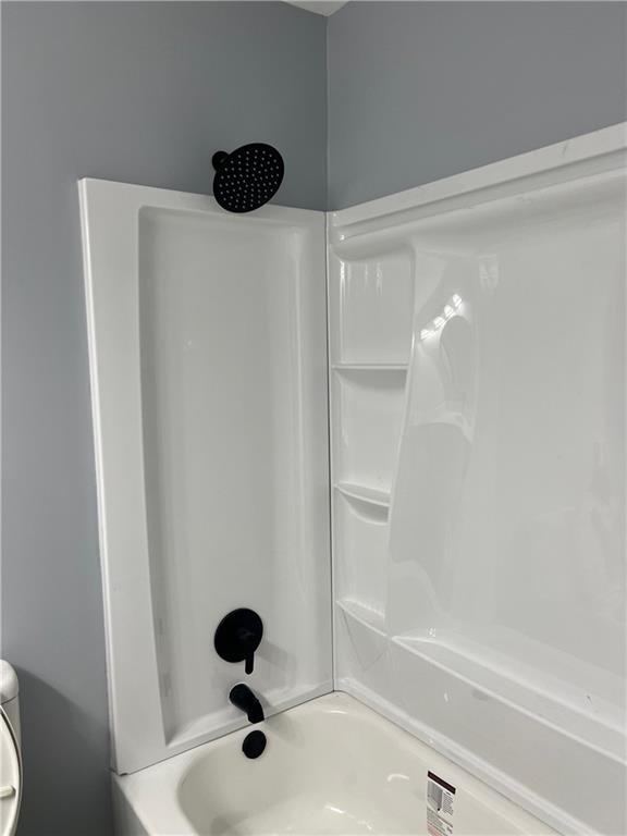 Bathroom with shower / bathing tub combination