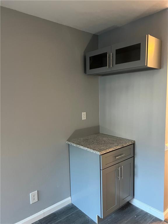 Kitchen featuring dark hardwood / wood-style flooring and gray cabinetry