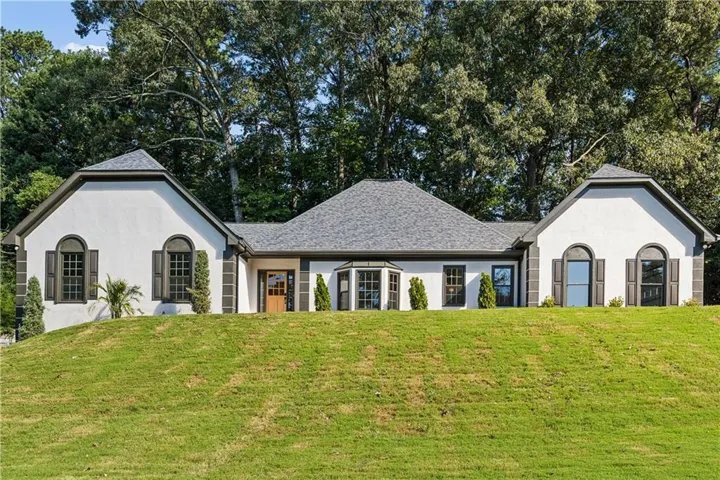 Stucco exterior with dark trim accents