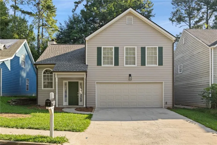 Light gray siding exterior with dark green shutters
