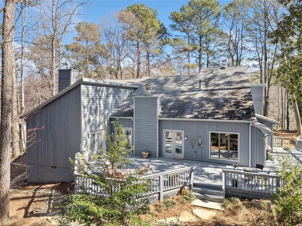 Back of home is paradise! A wrap around deck with entry from primary suite, great room, and kitchen!