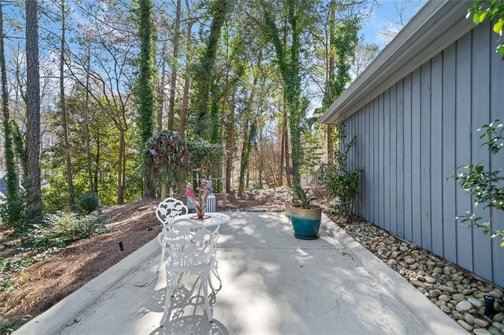 Super cute bistro area in the front of the home with gorgeous plantings