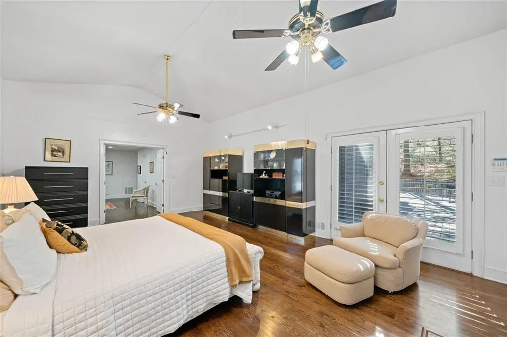 Primary suite featuring French doors to outdoor deck and a separate sitting area