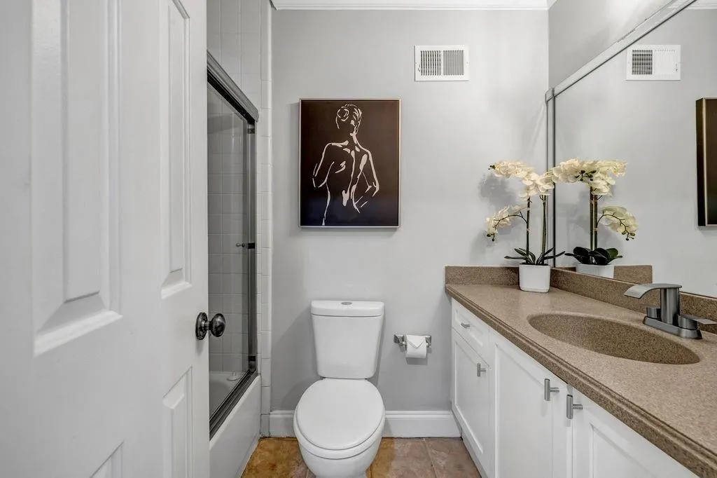 Bathroom with tile patterned floors, visible vents, toilet, and vanity