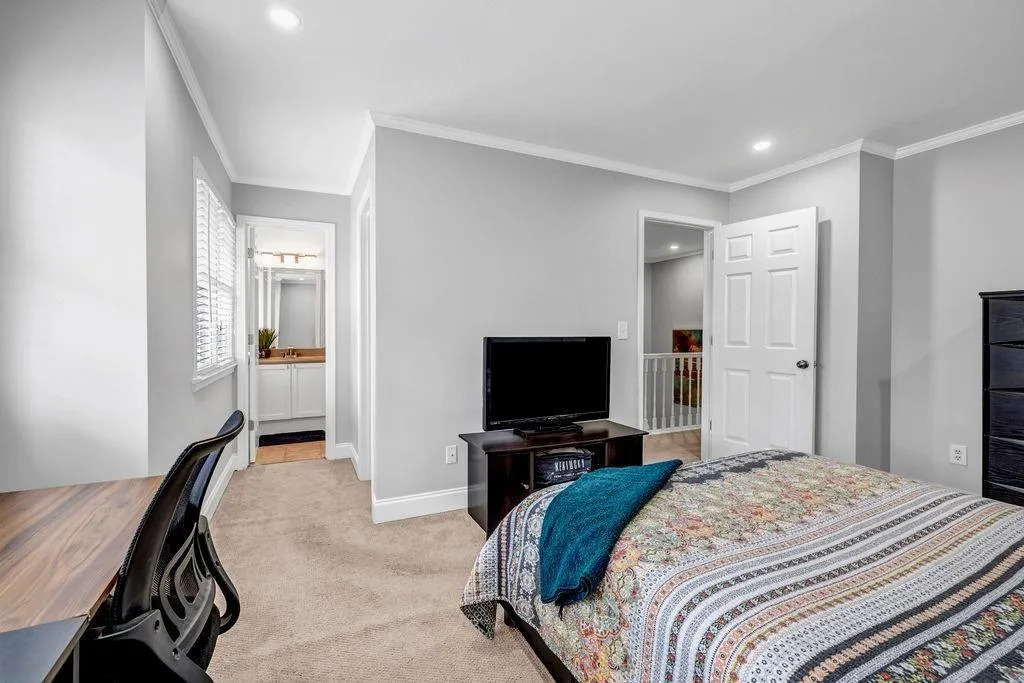 Carpeted bedroom featuring recessed lighting, baseboards, and ornamental molding