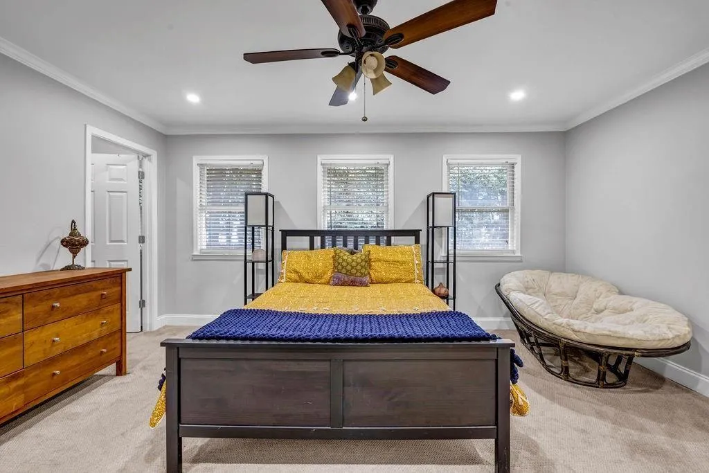 Bedroom featuring ornamental molding, recessed lighting, baseboards, and light carpet