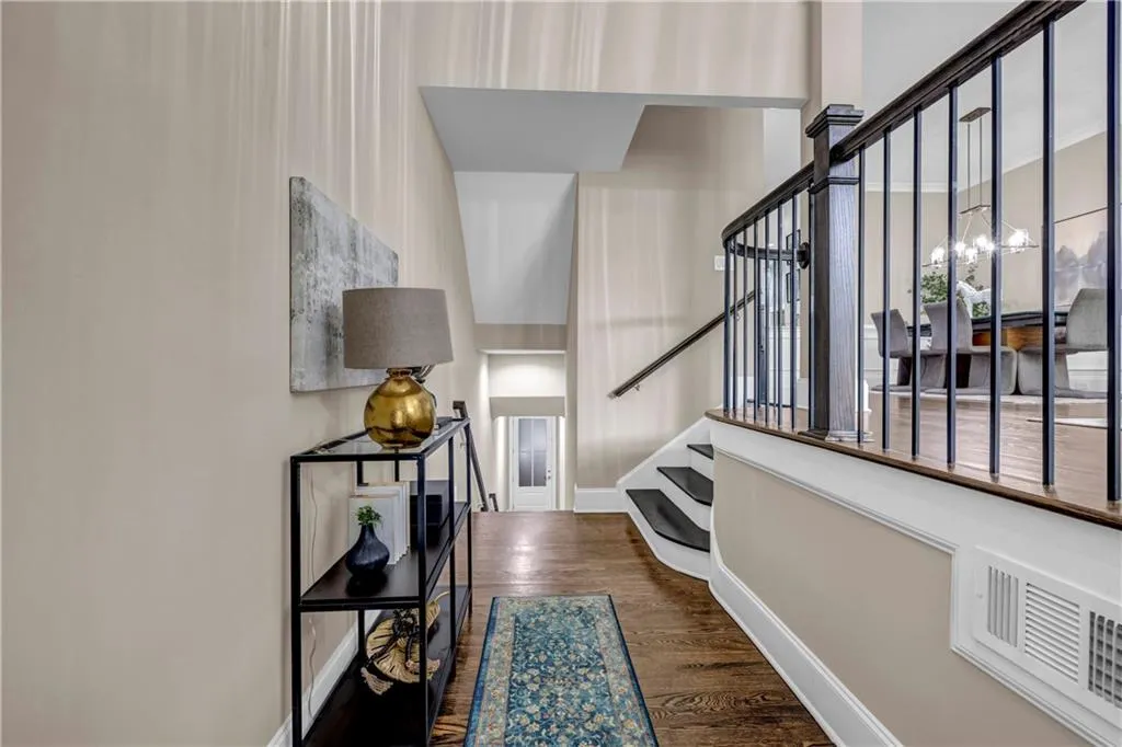 Foyer featuring dark wood-style floors and stairway