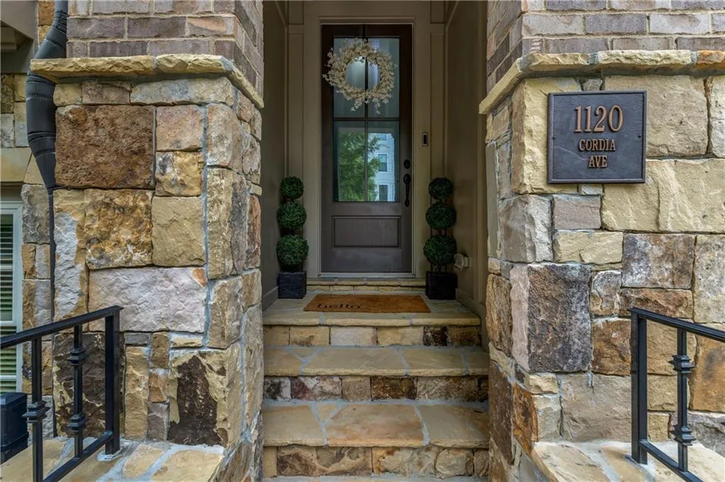 View of exterior entry featuring stone siding