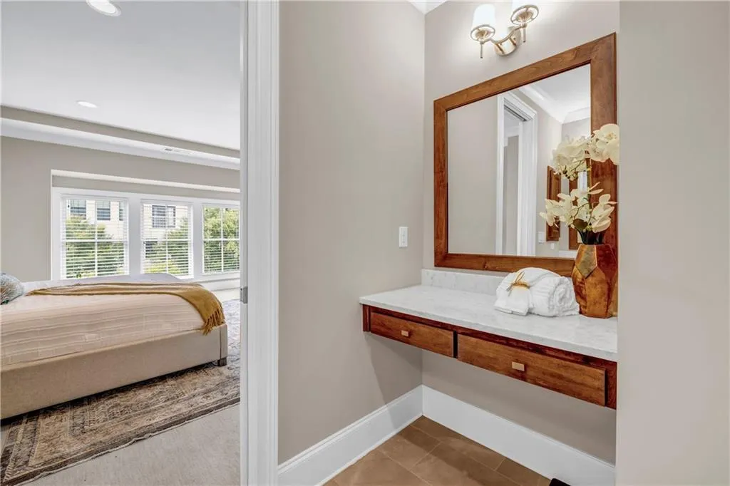 Ensuite bathroom featuring light tile patterned flooring, vanity, and recessed lighting
