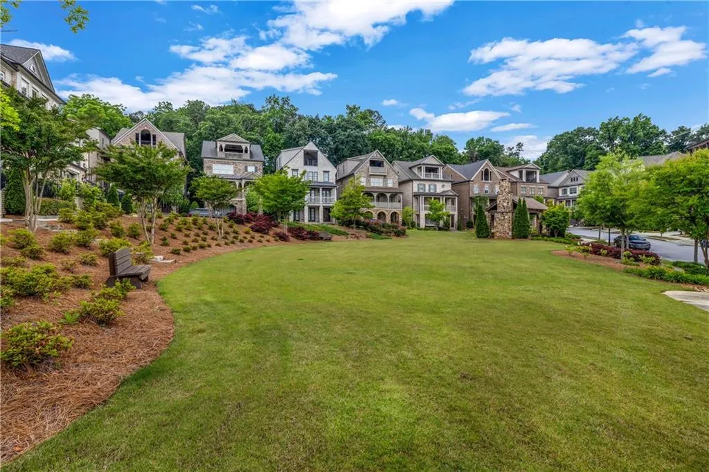 View of green lawn with a residential view