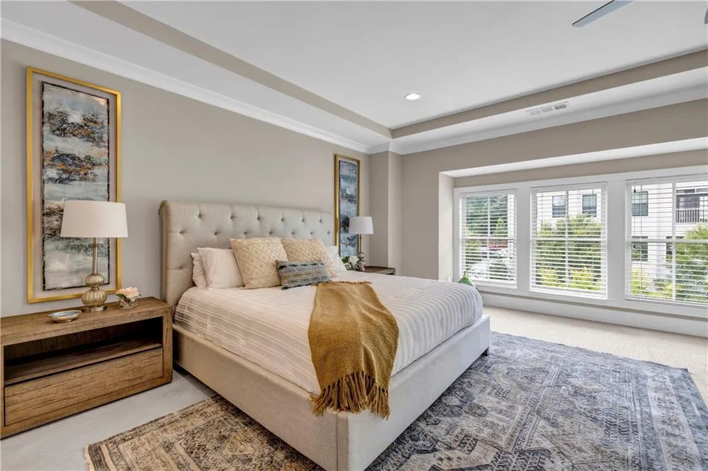 Bedroom featuring recessed lighting, light carpet, a raised ceiling, and ceiling fan