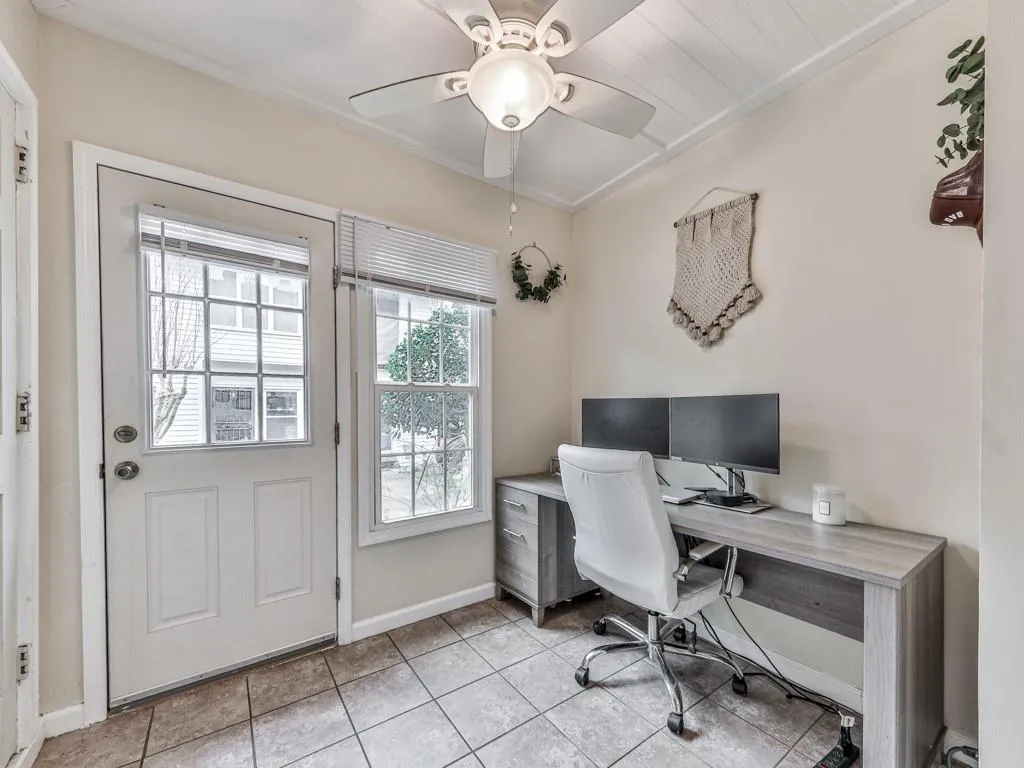 Office area featuring light tile patterned flooring and a ceiling fan
