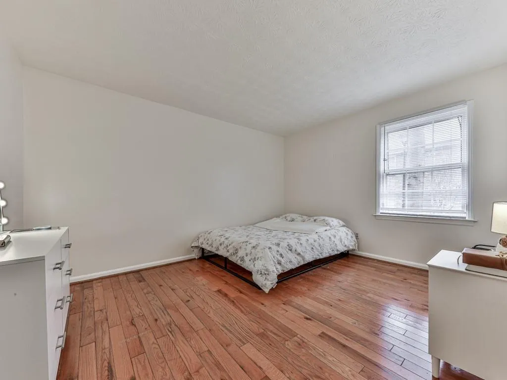 Bedroom featuring light wood finished floors and a textured ceiling