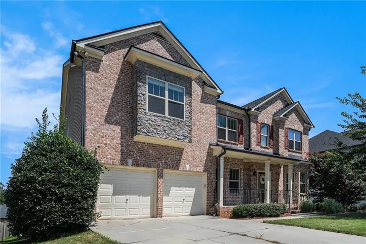 Craftsman house with covered porch, concrete driveway, brick siding, and a garage