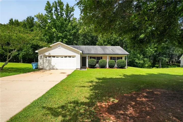 Ranch-style residence featuring white siding and a covered front porch