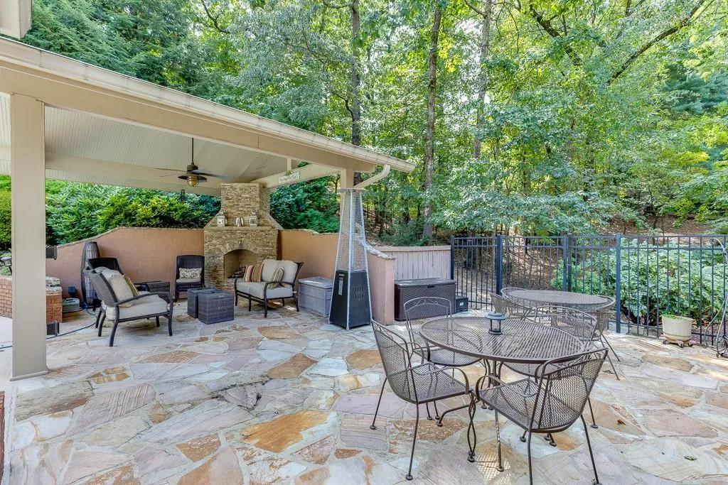 View of patio / terrace with an outdoor living space with a fireplace and ceiling fan