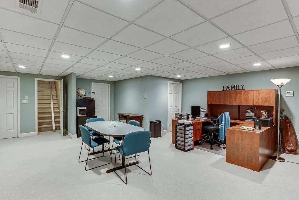 Dining space featuring light carpet and a paneled ceiling