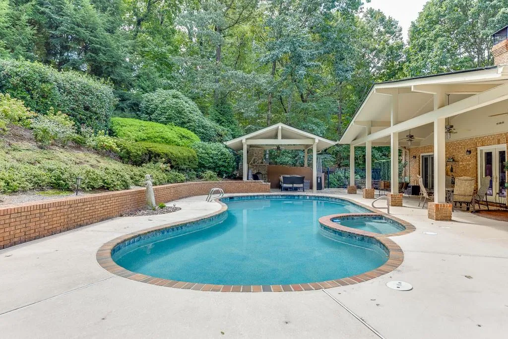 View of swimming pool featuring ceiling fan and a patio area