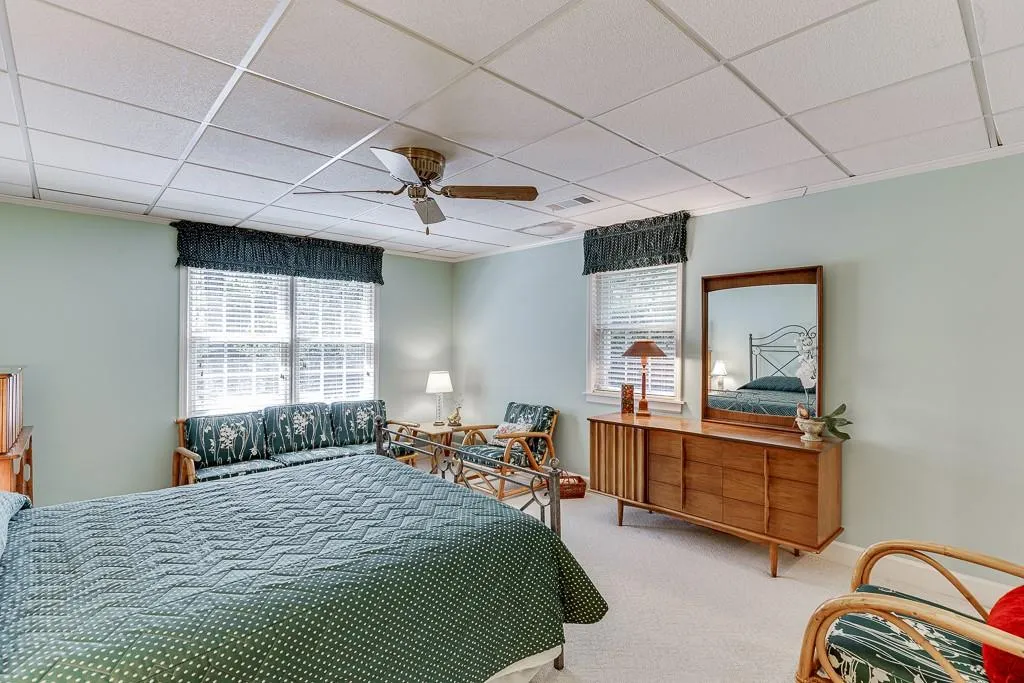 Bedroom featuring ceiling fan, carpet floors, and a paneled ceiling