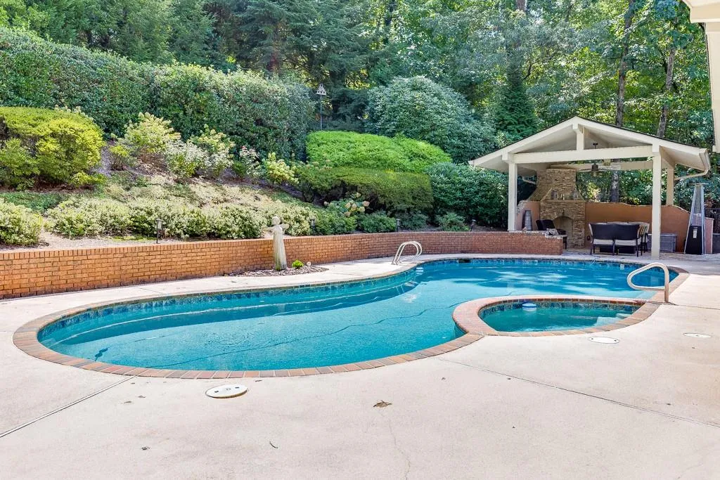 View of pool with an in ground hot tub and a patio area