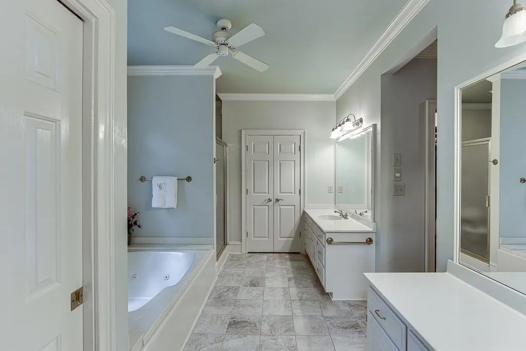 Bathroom with plus walk in shower, ceiling fan, vanity, and crown molding