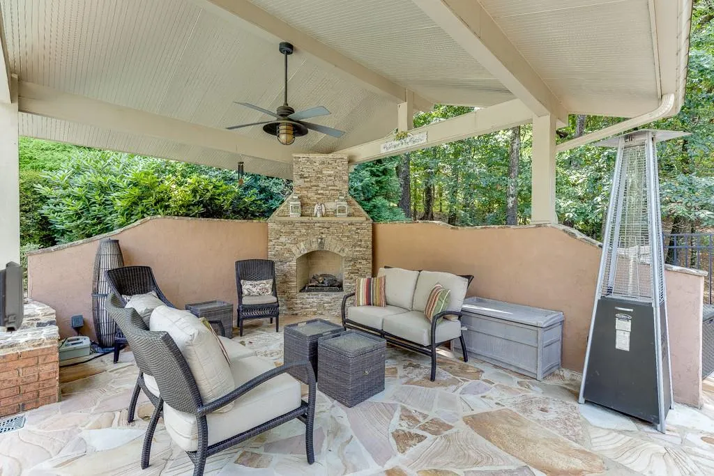 View of patio featuring an outdoor living space with a fireplace and ceiling fan
