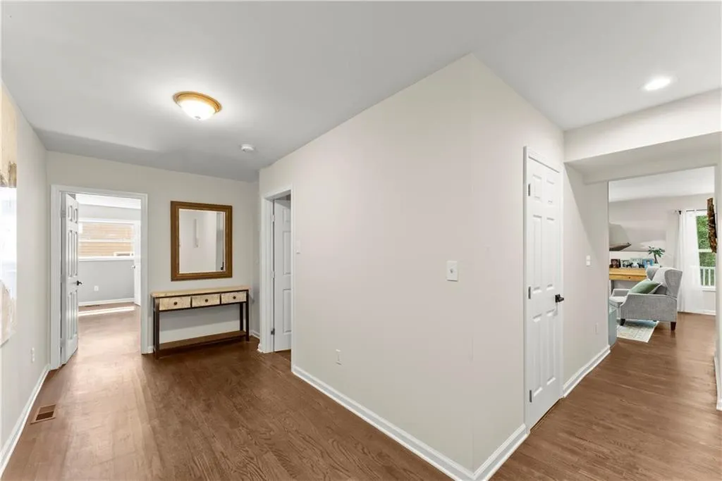 Hallway with dark wood-style flooring