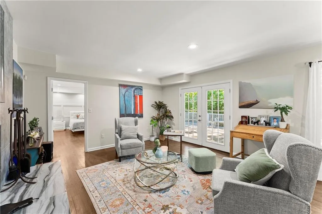 Living area with wood finished floors, recessed lighting, and french doors