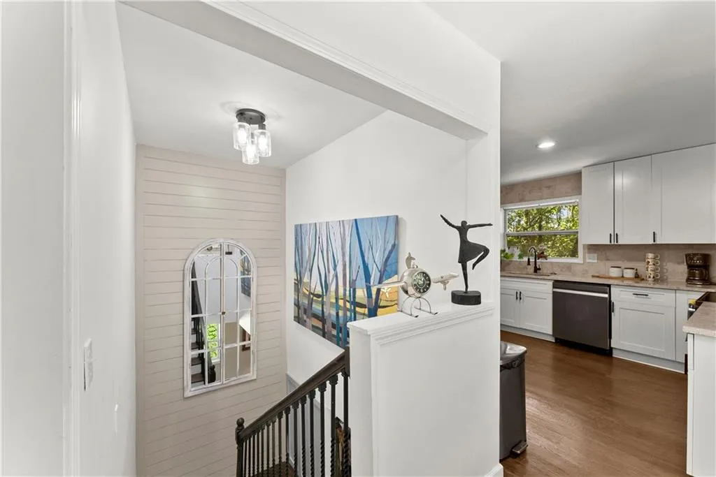 Hall with dark wood-type flooring and recessed lighting