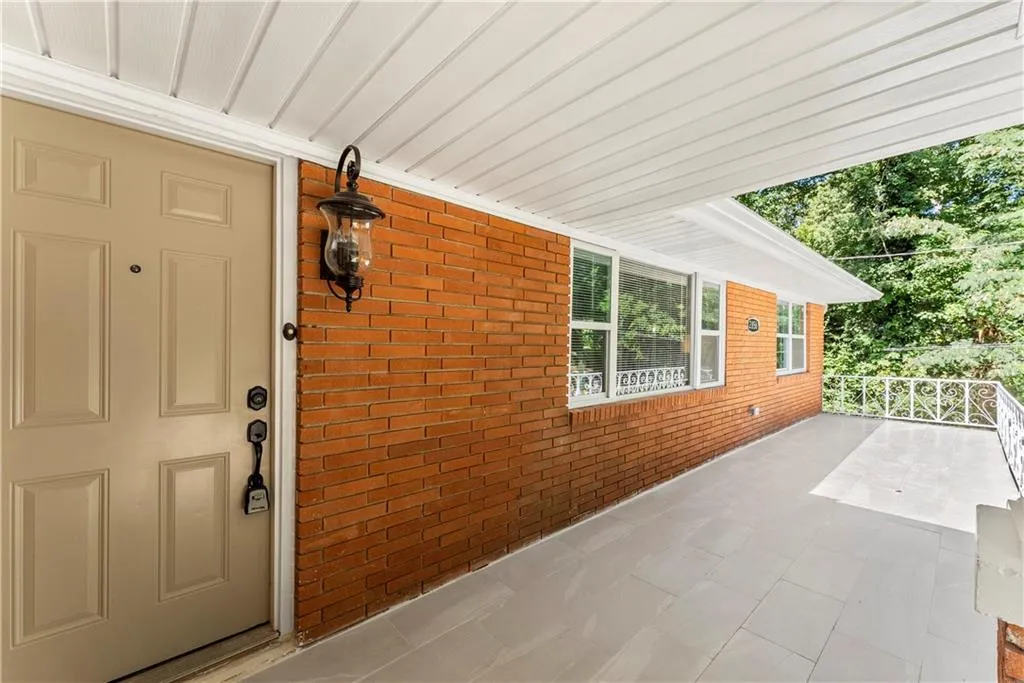 Property entrance featuring brick siding