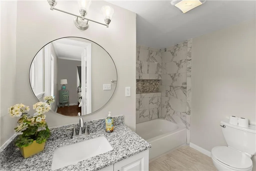 Bathroom with vanity and shower / washtub combination