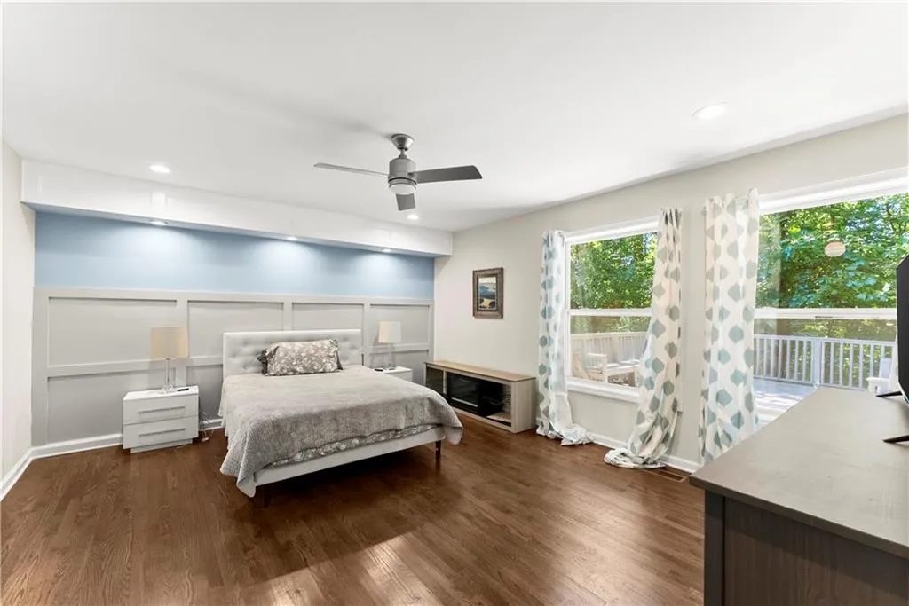 Bedroom with dark wood-style flooring, access to exterior, ceiling fan, and recessed lighting