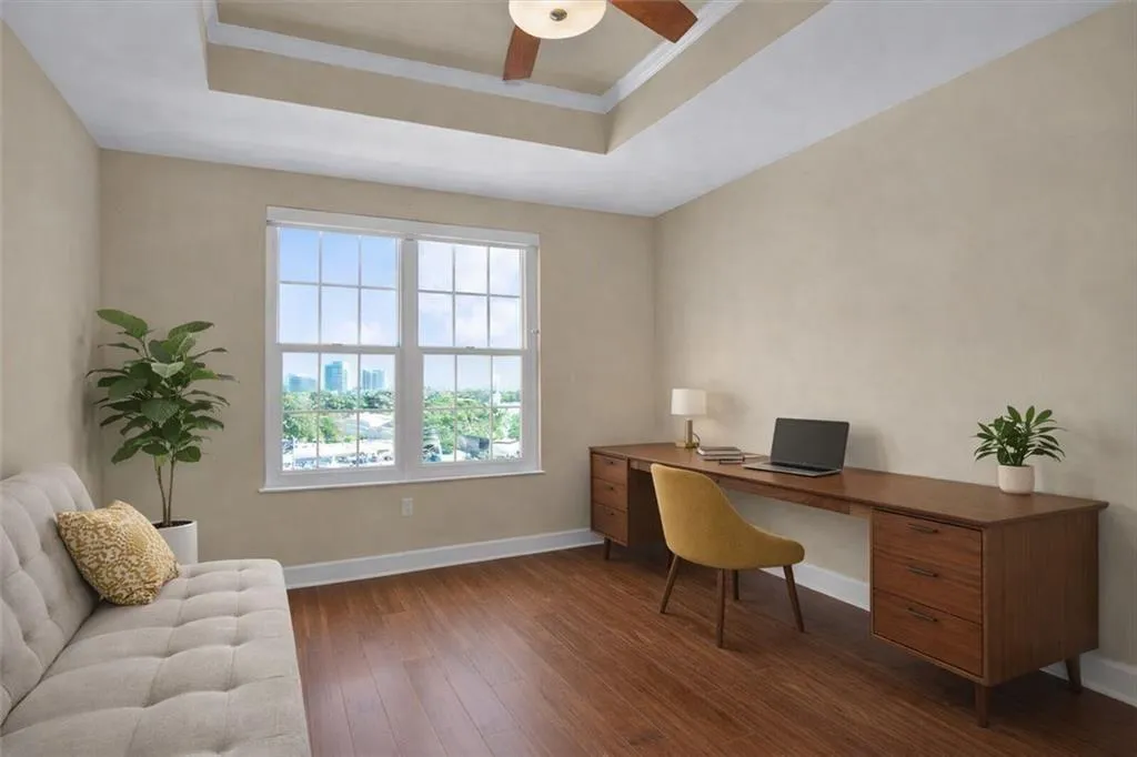 Bedroom 2 with skyline views, wood floors throughout