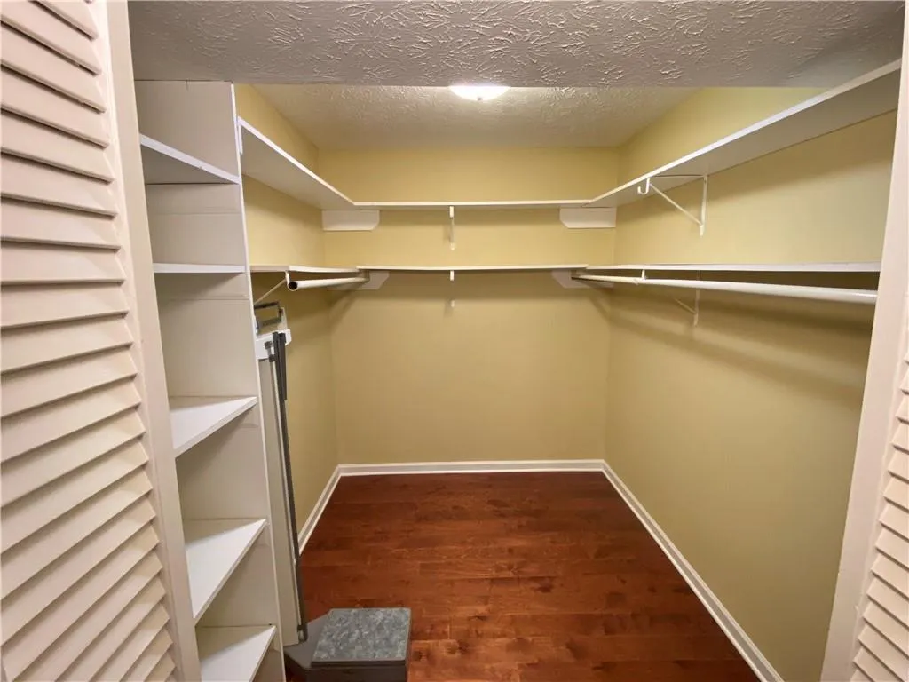Spacious closet featuring hardwood / wood-style floors