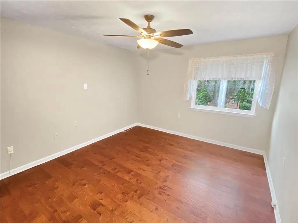 Bedroom featuring hardwood / wood-style flooring and ceiling fan