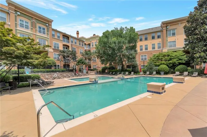 Resort-style pool with integrated spa and ample lounge seating